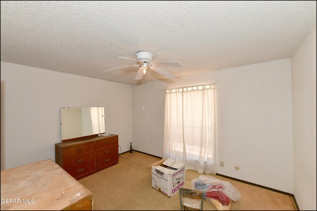 312 Caporal Ct, El Paso, TX 79932 - unfurnished bedroom with light colored carpet, a textured ceiling, and a ceiling fan