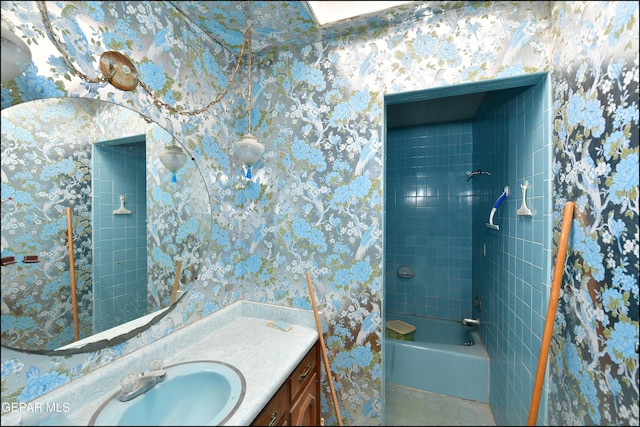 312 Caporal Ct, El Paso, TX 79932 - bathroom with vanity, washtub / shower combination, and wallpapered walls