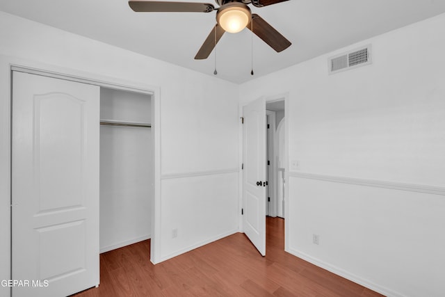 7461 Plaza Redonda Dr, El Paso, TX 79912 - unfurnished bedroom featuring wood finished floors, a closet, and baseboards