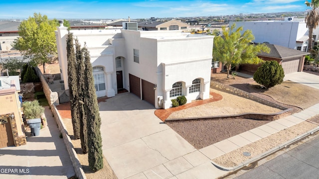7461 Plaza Redonda Dr, El Paso, TX 79912 - view of front facade with driveway and stucco siding