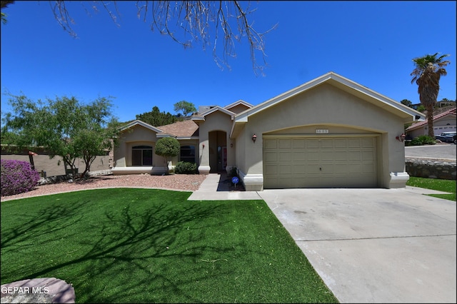 6609 El Poste Ct, El Paso, TX 79912 - ranch-style house with stucco siding, concrete driveway, an attached garage, and a front lawn