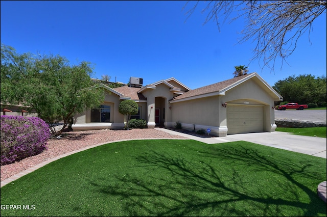 6609 El Poste Ct, El Paso, TX 79912 - single story home with stucco siding, a garage, driveway, a front lawn, and central AC