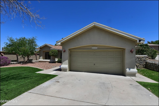 6609 El Poste Ct, El Paso, TX 79912 - single story home with stucco siding, a front yard, concrete driveway, and a garage