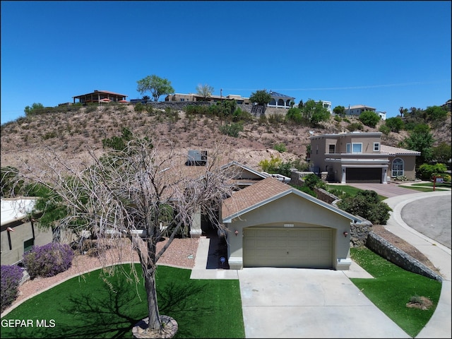 6609 El Poste Ct, El Paso, TX 79912 - view of front of home featuring driveway, stucco siding, and a garage