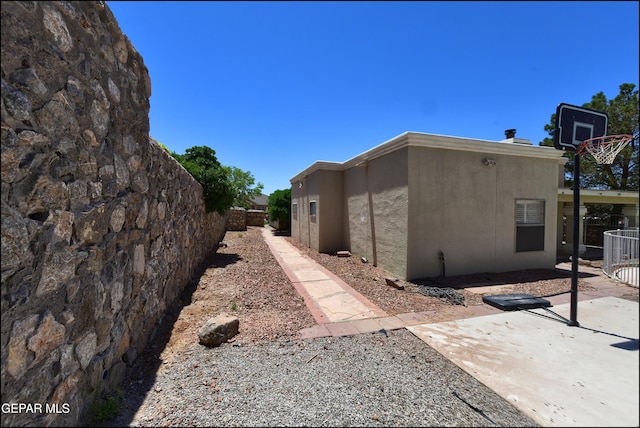 6609 El Poste Ct, El Paso, TX 79912 - view of side of home featuring stucco siding and a patio