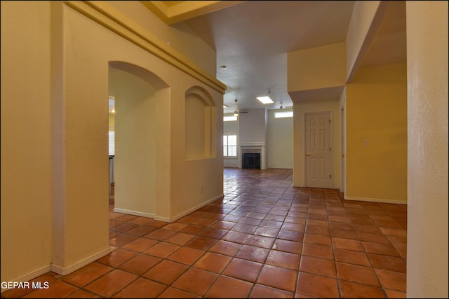 6609 El Poste Ct, El Paso, TX 79912 - empty room featuring a fireplace, light tile patterned floors, and baseboards