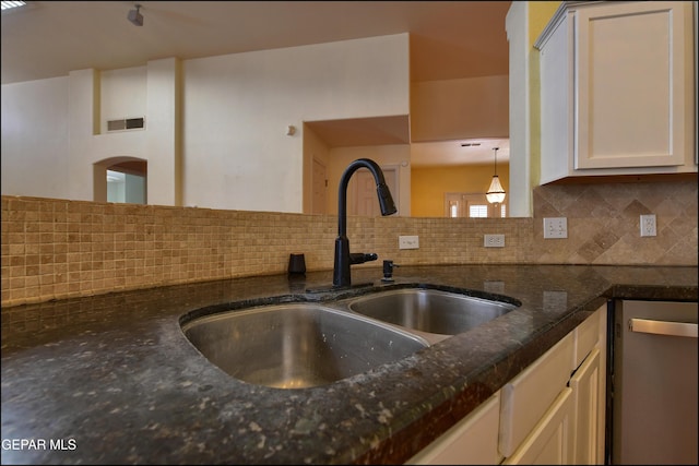 6609 El Poste Ct, El Paso, TX 79912 - kitchen with a sink, dishwasher, backsplash, and dark stone counters