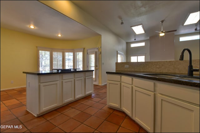 6609 El Poste Ct, El Paso, TX 79912 - kitchen featuring a sink, light tile patterned floors, white cabinetry, tasteful backsplash, and recessed lighting