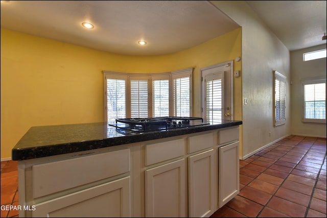 6609 El Poste Ct, El Paso, TX 79912 - kitchen featuring black gas stovetop, white cabinets, tile patterned floors, baseboards, and dark countertops