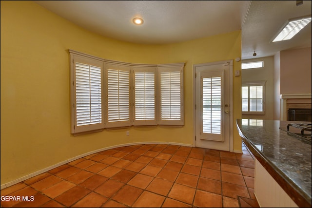 6609 El Poste Ct, El Paso, TX 79912 - unfurnished dining area with light tile patterned flooring and a fireplace