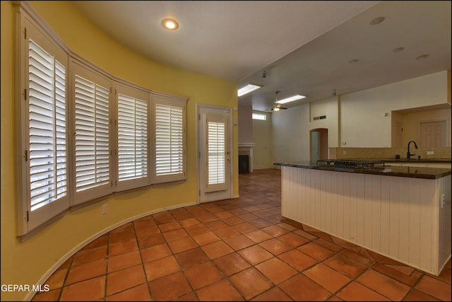 6609 El Poste Ct, El Paso, TX 79912 - kitchen featuring dark countertops, tile patterned flooring, a sink, and recessed lighting