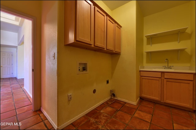 6609 El Poste Ct, El Paso, TX 79912 - washroom with hookup for an electric dryer, hookup for a washing machine, cabinet space, bar with sink, and baseboards