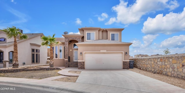 3199 Red Maple Dr, El Paso, TX 79938 - view of front of home featuring stone siding, stucco siding, concrete driveway, and a garage