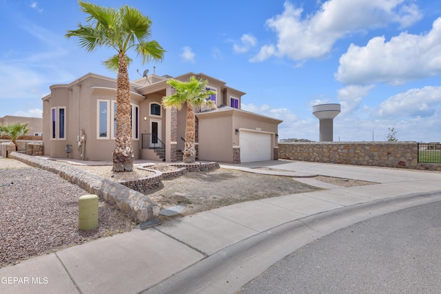 3199 Red Maple Dr, El Paso, TX 79938 - view of front facade featuring stucco siding, concrete driveway, stone siding, and an attached garage