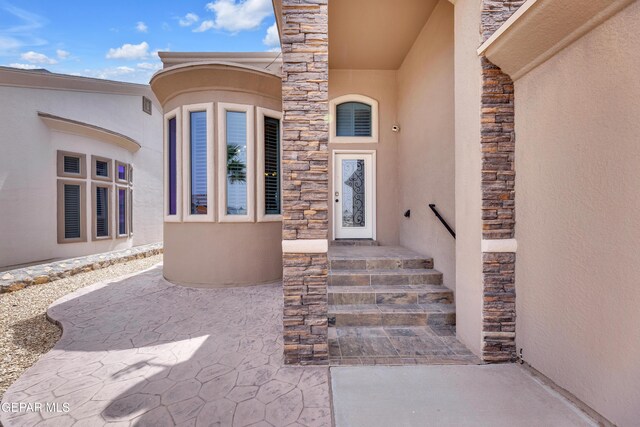3199 Red Maple Dr, El Paso, TX 79938 - doorway to property featuring stone siding and stucco siding