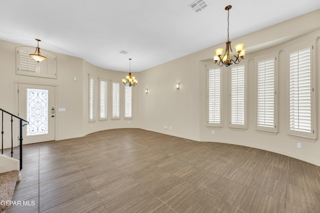 3199 Red Maple Dr, El Paso, TX 79938 - unfurnished living room featuring a chandelier, stairway, and baseboards