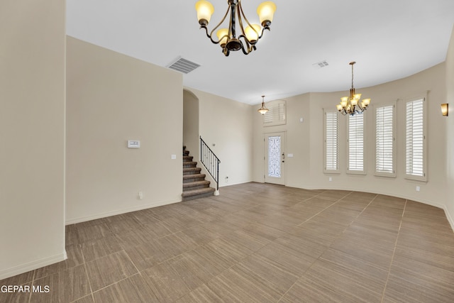 3199 Red Maple Dr, El Paso, TX 79938 - unfurnished living room featuring a chandelier, stairway, plenty of natural light, and arched walkways