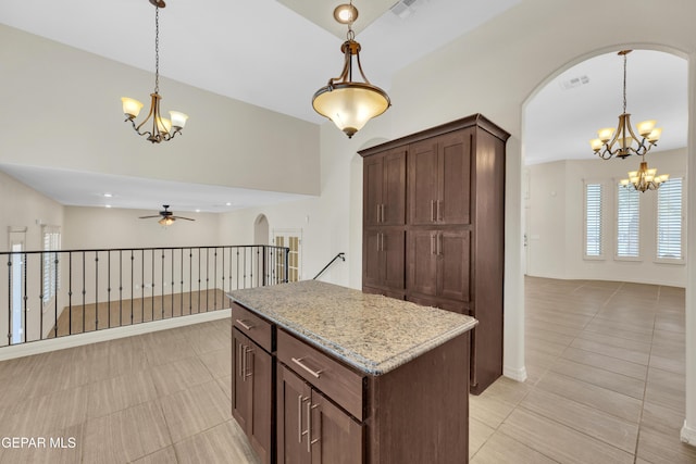 3199 Red Maple Dr, El Paso, TX 79938 - kitchen with a chandelier, arched walkways, open floor plan, and ceiling fan