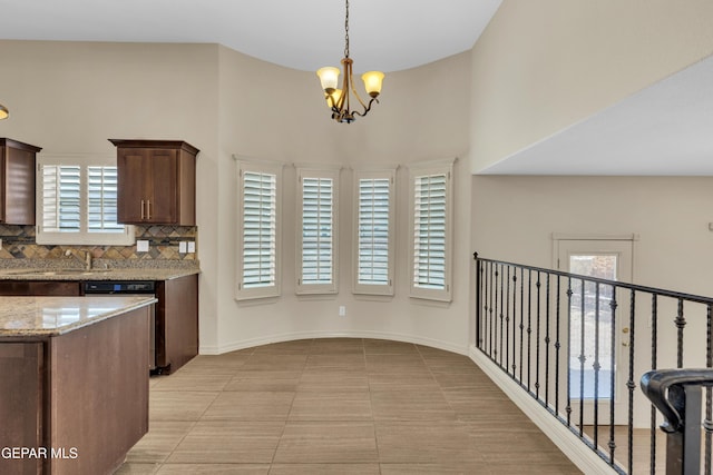 3199 Red Maple Dr, El Paso, TX 79938 - kitchen featuring a chandelier, tasteful backsplash, light stone counters, hanging light fixtures, and dishwasher