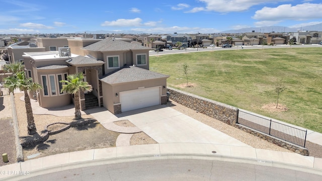 3199 Red Maple Dr, El Paso, TX 79938 - view of front of home with stucco siding, a residential view, a front yard, driveway, and a mountain view