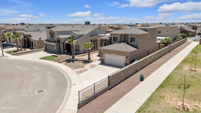 3199 Red Maple Dr, El Paso, TX 79938 - view of front of property featuring a residential view, driveway, an attached garage, and stucco siding