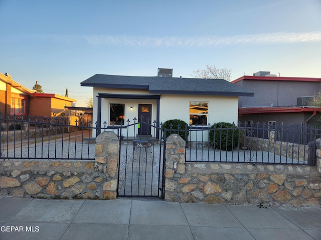 4122 Cumberland Ave, El Paso, TX 79903 - view of front facade with a fenced front yard, a gate, a shingled roof, and brick siding
