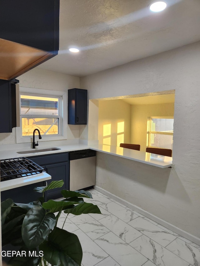 4122 Cumberland Ave, El Paso, TX 79903 - kitchen featuring dishwasher, a sink, baseboards, light countertops, and light marble finish flooring