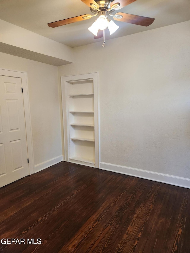 4122 Cumberland Ave, El Paso, TX 79903 - empty room featuring baseboards, built in features, a ceiling fan, and dark wood finished floors