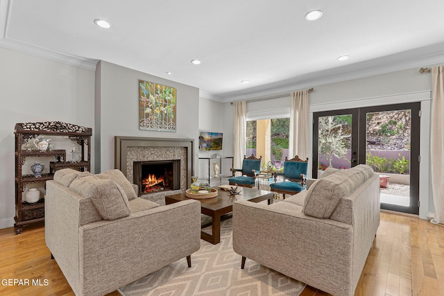1119 Los Jardines Cir, El Paso, TX 79912 - living room featuring ornamental molding, a premium fireplace, recessed lighting, light wood finished floors, and french doors