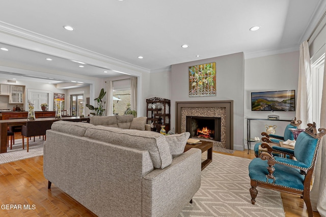 1119 Los Jardines Cir, El Paso, TX 79912 - living room with crown molding, light wood-style floors, recessed lighting, and a high end fireplace
