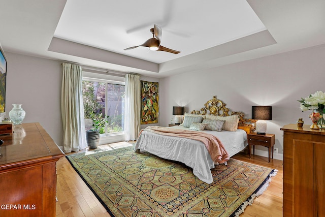 1119 Los Jardines Cir, El Paso, TX 79912 - bedroom featuring a tray ceiling, light wood-style flooring, and ceiling fan