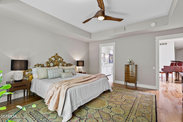 1119 Los Jardines Cir, El Paso, TX 79912 - bedroom featuring wood finished floors, baseboards, ceiling fan, and ensuite bathroom