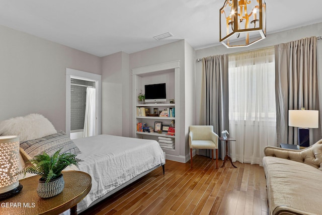 1119 Los Jardines Cir, El Paso, TX 79912 - bedroom with a chandelier and hardwood / wood-style flooring