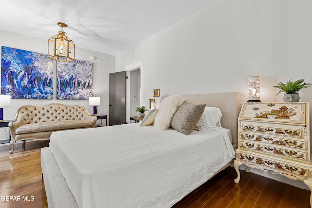 1119 Los Jardines Cir, El Paso, TX 79912 - bedroom featuring wood finished floors and a chandelier