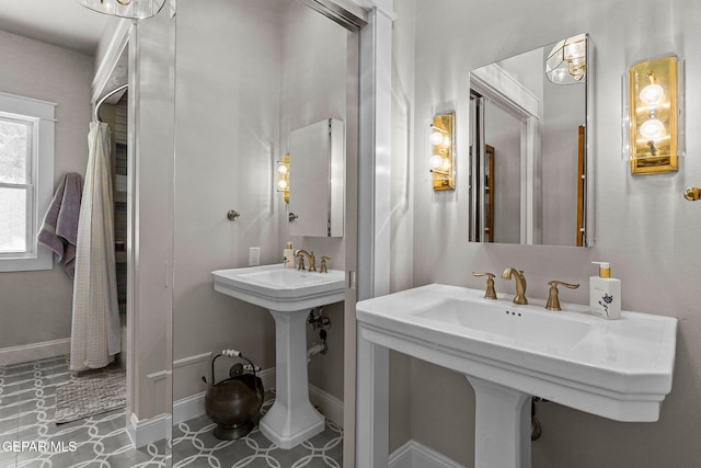 1119 Los Jardines Cir, El Paso, TX 79912 - bathroom featuring baseboards and a sink