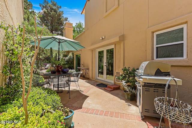 1119 Los Jardines Cir, El Paso, TX 79912 - view of patio with french doors, outdoor dining space, and grilling area