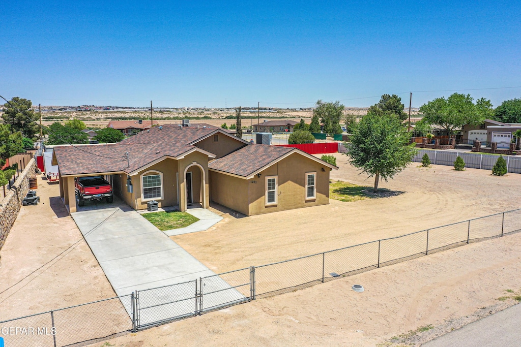 11291 Mark Mabon Ct, Socorro, TX 79927 - view of front of property featuring driveway, stucco siding, a carport, a shingled roof, and a gate