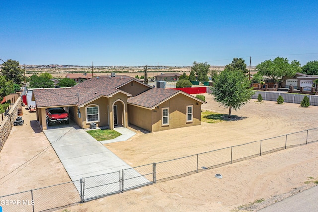 11291 Mark Mabon Ct, Socorro, TX 79927 - view of front of property featuring driveway, stucco siding, a carport, a shingled roof, and a gate