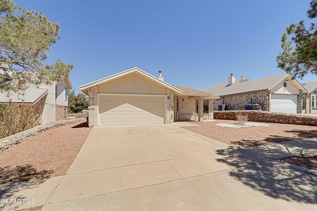 7145 Golden Hawk Dr, El Paso, TX 79912 - ranch-style house with brick siding, driveway, a garage, and board and batten siding