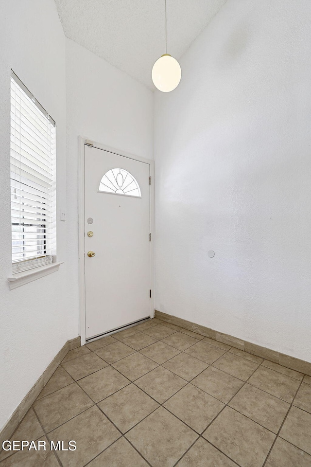 7145 Golden Hawk Dr, El Paso, TX 79912 - foyer entrance featuring light tile patterned flooring and baseboards
