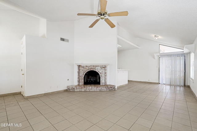 7145 Golden Hawk Dr, El Paso, TX 79912 - unfurnished living room featuring high vaulted ceiling, light tile patterned flooring, ceiling fan, a brick fireplace, and baseboards
