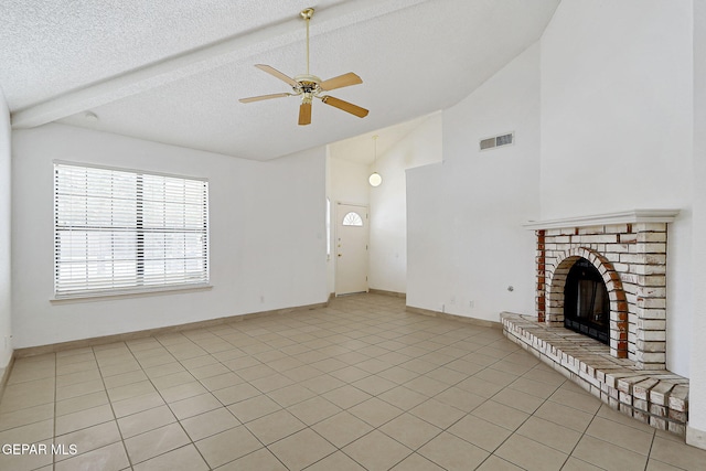 7145 Golden Hawk Dr, El Paso, TX 79912 - unfurnished living room featuring a ceiling fan, a brick fireplace, a textured ceiling, light tile patterned floors, and baseboards