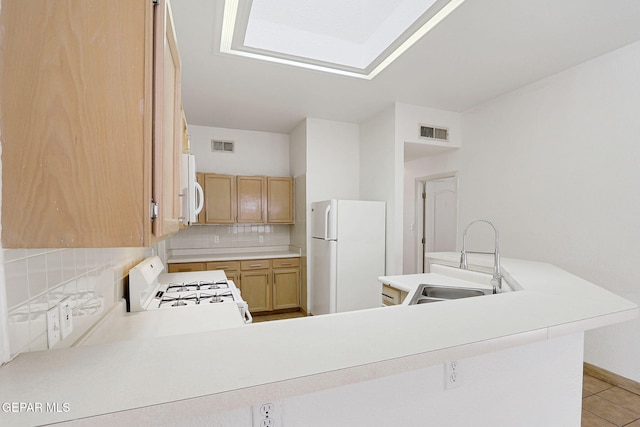 7145 Golden Hawk Dr, El Paso, TX 79912 - kitchen featuring white appliances, a sink, tasteful backsplash, light countertops, and light tile patterned floors