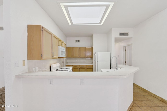 7145 Golden Hawk Dr, El Paso, TX 79912 - kitchen featuring white appliances, backsplash, and light countertops