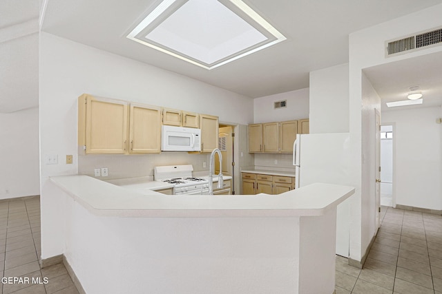 7145 Golden Hawk Dr, El Paso, TX 79912 - kitchen featuring white appliances, light brown cabinetry, light tile patterned floors, and light countertops
