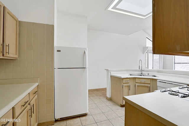 7145 Golden Hawk Dr, El Paso, TX 79912 - kitchen featuring freestanding refrigerator, a sink, tile walls, light tile patterned flooring, and light countertops