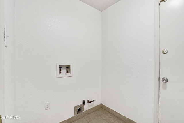 7145 Golden Hawk Dr, El Paso, TX 79912 - laundry room with washer hookup, gas dryer hookup, light tile patterned flooring, and baseboards