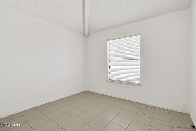 7145 Golden Hawk Dr, El Paso, TX 79912 - spare room featuring vaulted ceiling, a textured ceiling, and baseboards