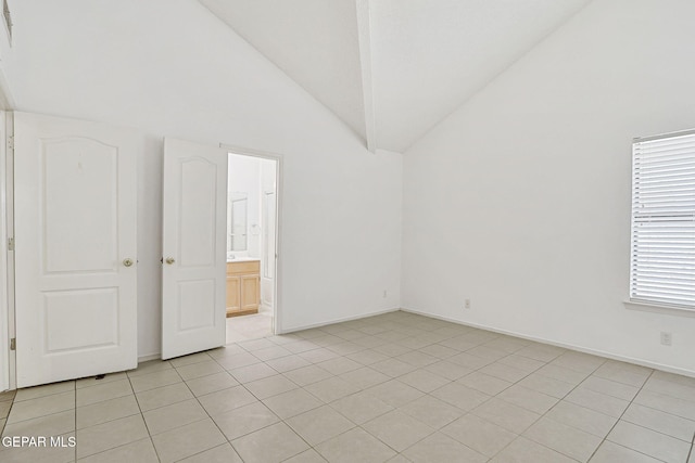 7145 Golden Hawk Dr, El Paso, TX 79912 - spare room featuring lofted ceiling, light tile patterned floors, and baseboards