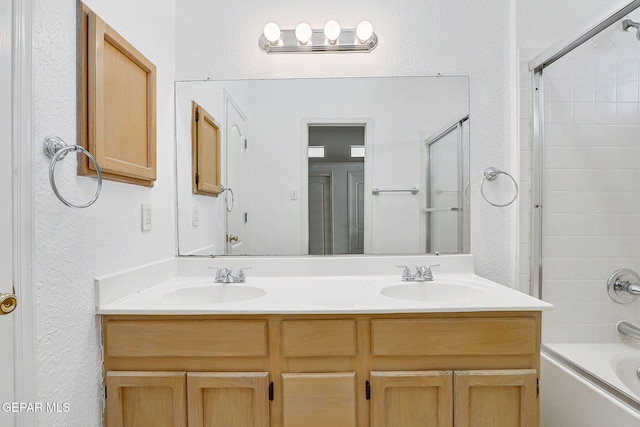 7145 Golden Hawk Dr, El Paso, TX 79912 - full bathroom with double vanity, a textured wall, and washtub / shower combination